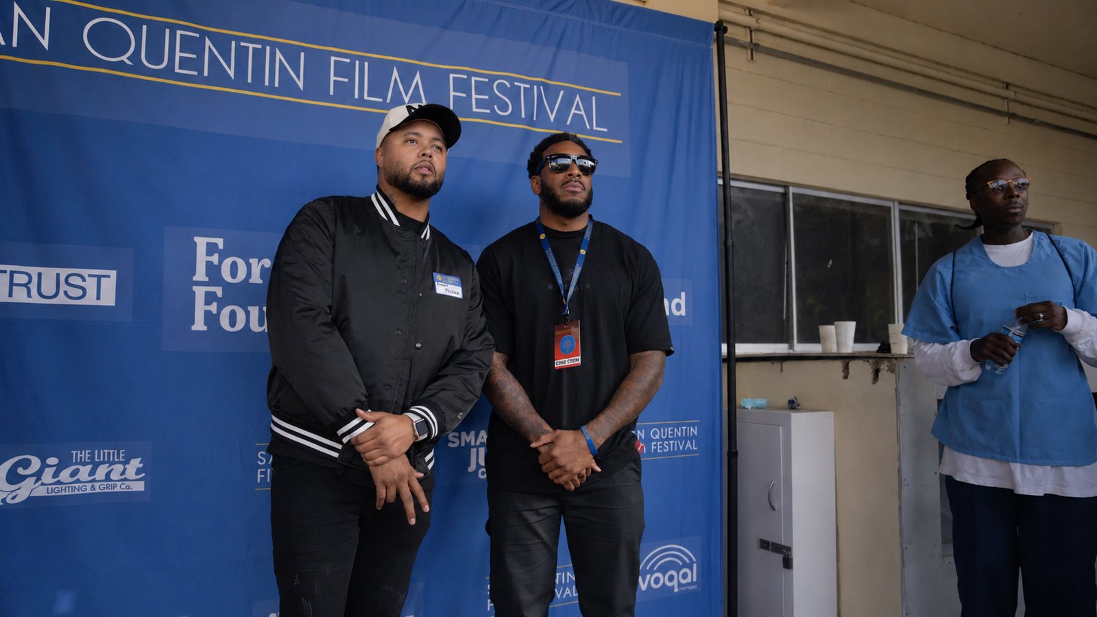 Guests pose at the San Quentin Film Festival step-and-repeat