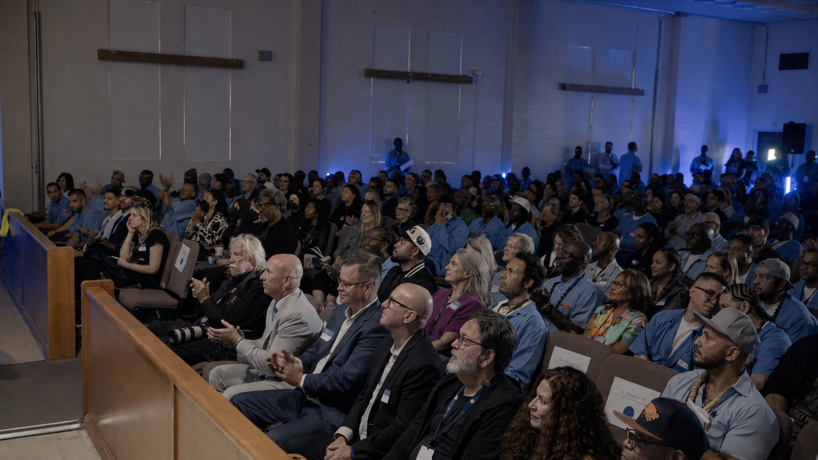 A full house of incarcerated men and invited guests seated together